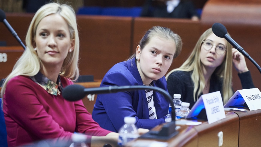 Three youth delegates attending a congress' session